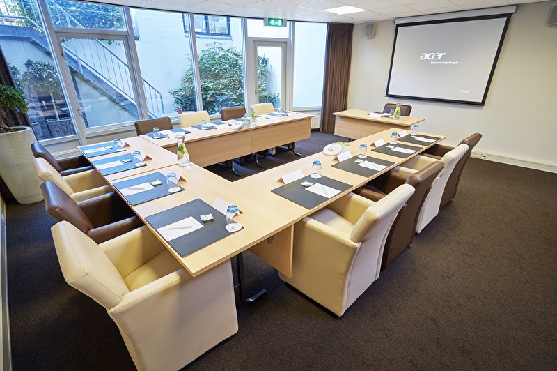 A spacious meeting room with a central table, perfect for gatherings and meetings.